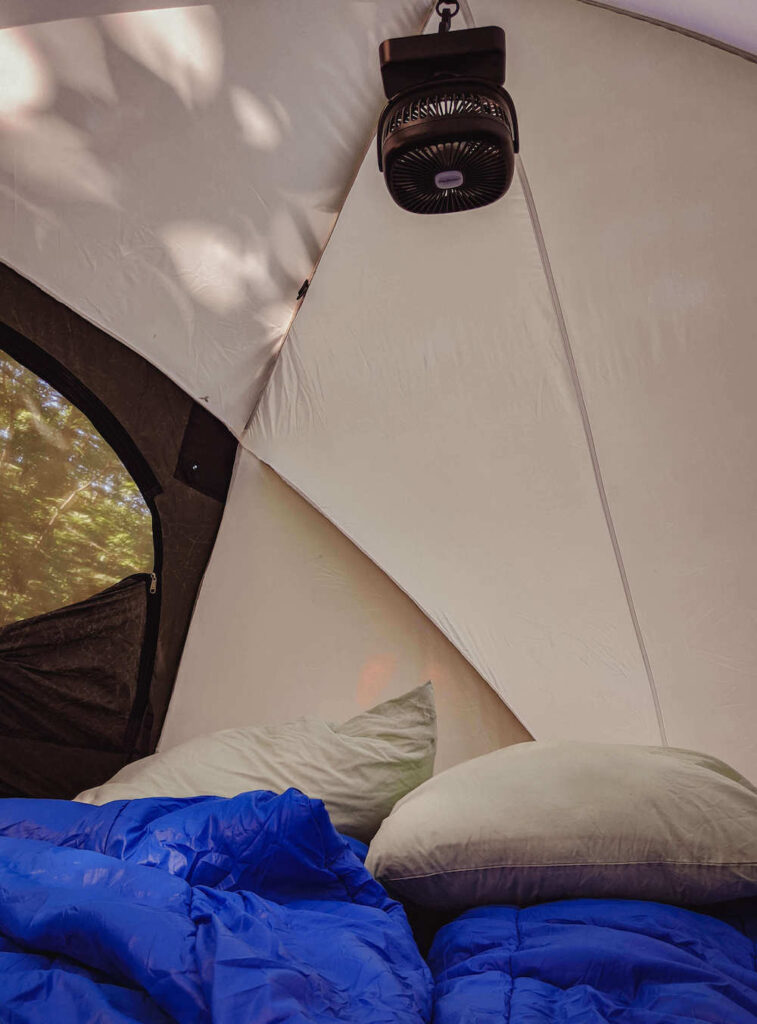 Tent with a fan and sleeping pads to make your first time camping easier and comfier - tent camping for beginners