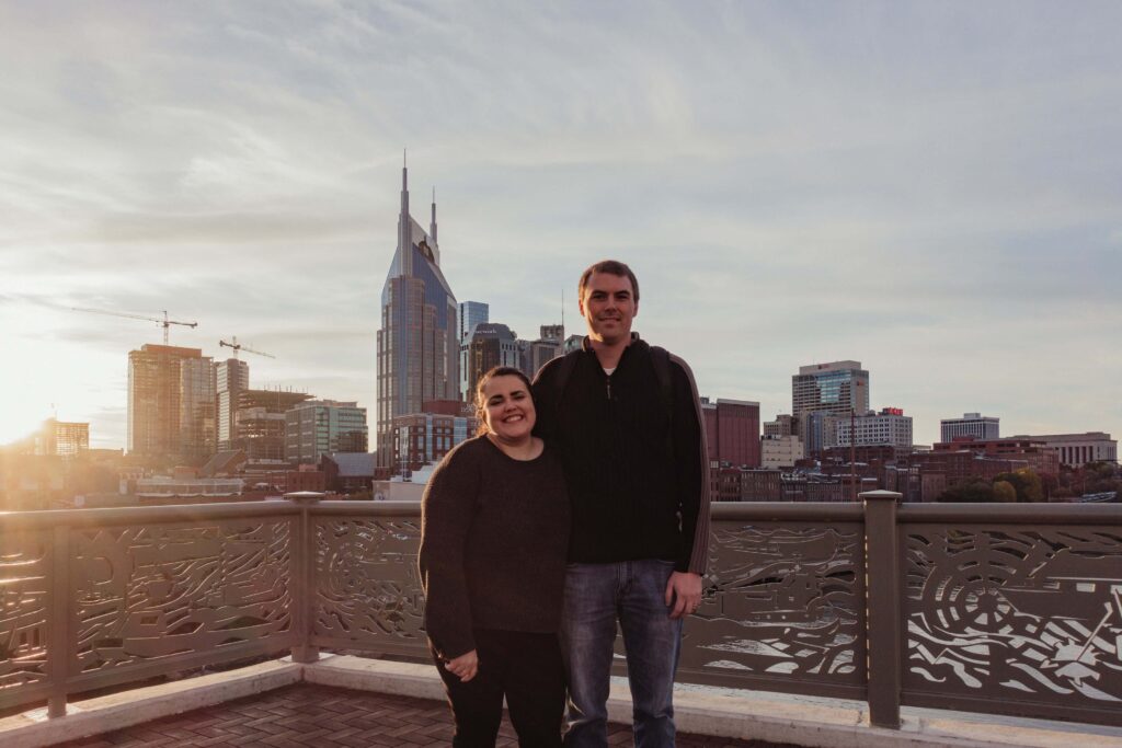 A view of us and the Nashville skyline from the John Seigenthaler Pedestrian Bridge in Nashville Tennesee.  A must see stop on our Nashville Weekend Itinerary
