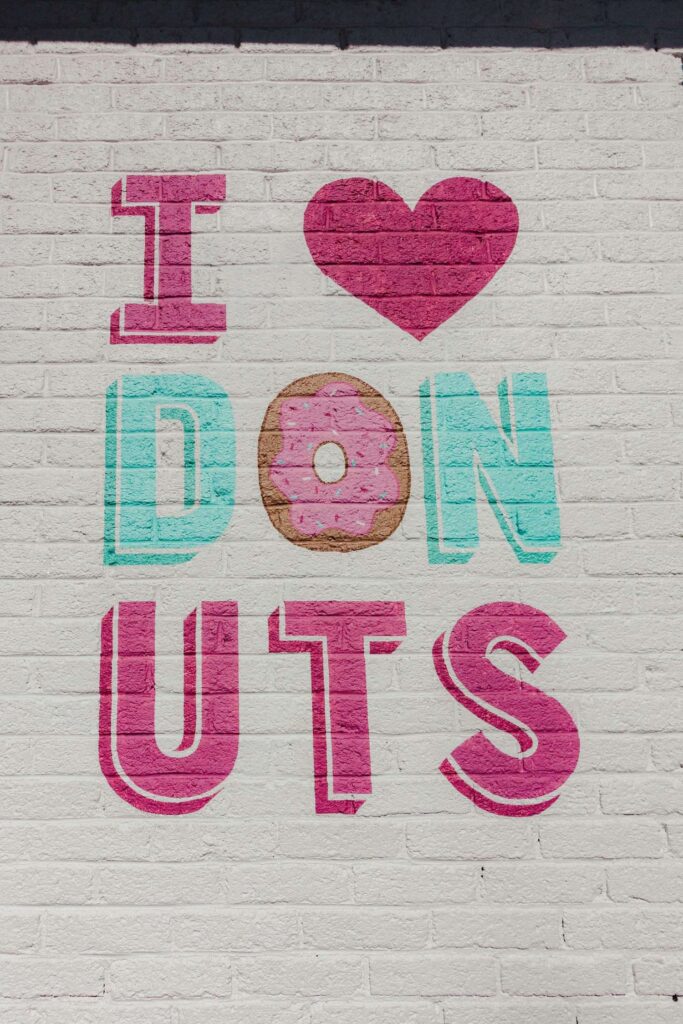 This stop at Five Daughters Bakery in Nashville was a must see stop on our Nashville Weekend Itinerary.  The mural painted on the side of their building reads "I [heart] Donuts"