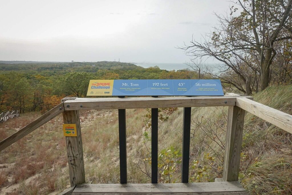 A Sign at the top of Mount Tom that says 192 Feet, 43 degree elevation, 3 dune challenge.