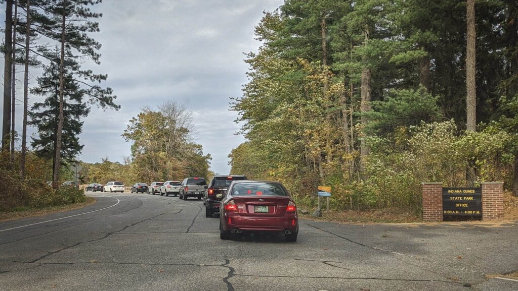 A long line of cars to enter Indiana Dunes State Park.  