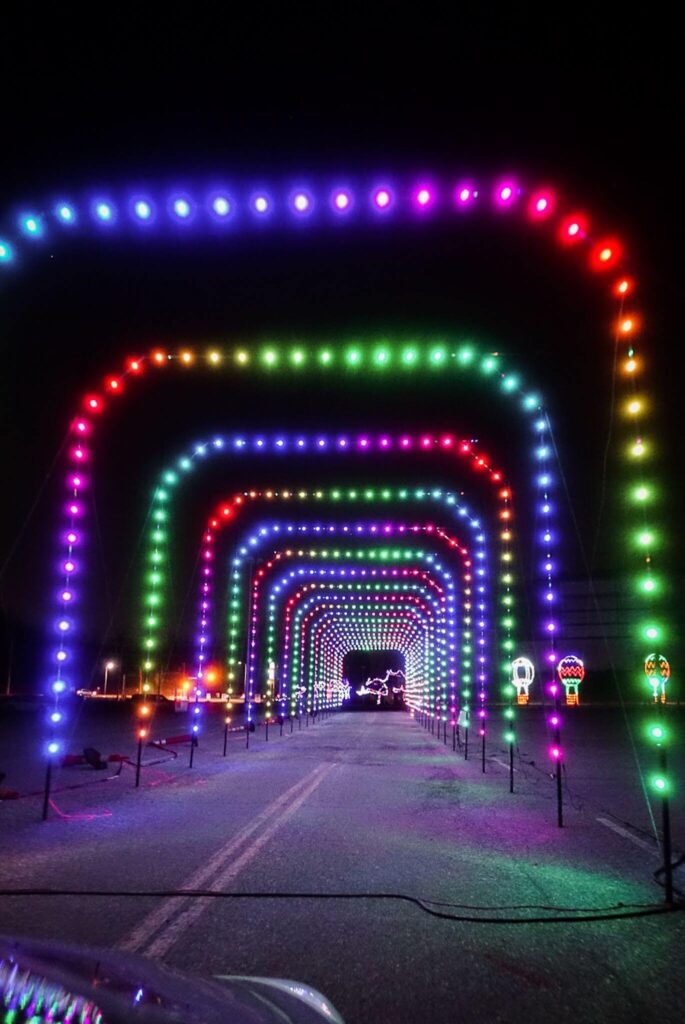 A tunnel of Christmas lights in a rainbow of colors. 