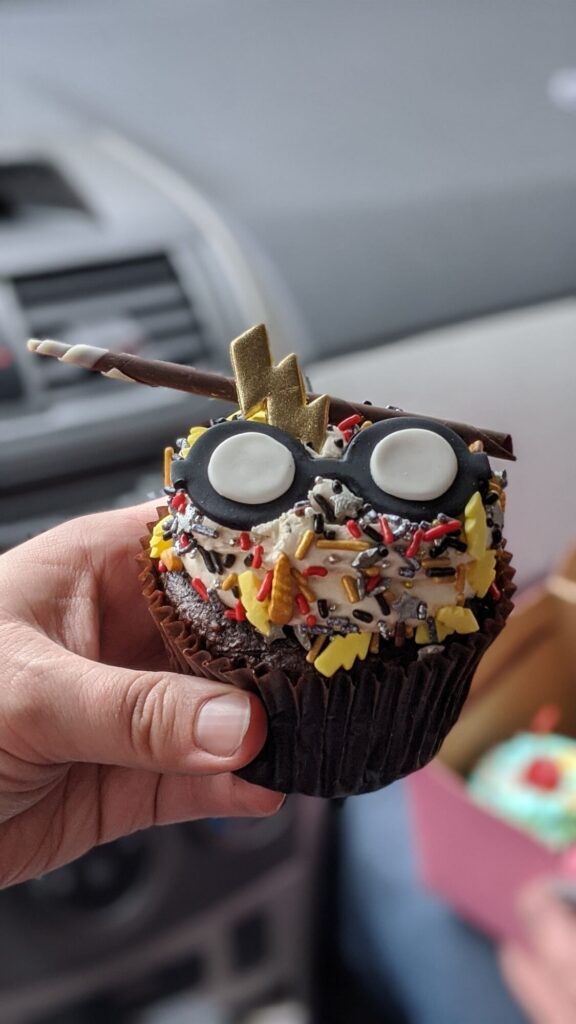 A chocolate cupcake with round fondant glasses and a lightning bolt like Harry Potter - Designer Desserts - Things to do Near Indiana Dunes National Park